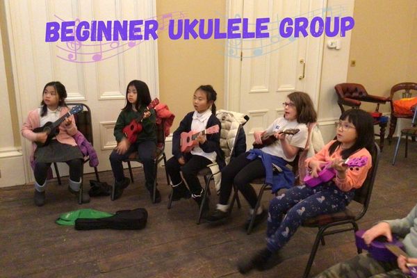 group of young children playing colourful ukuleles
