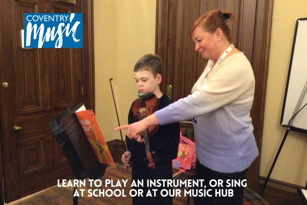 child having individual violin lesson
